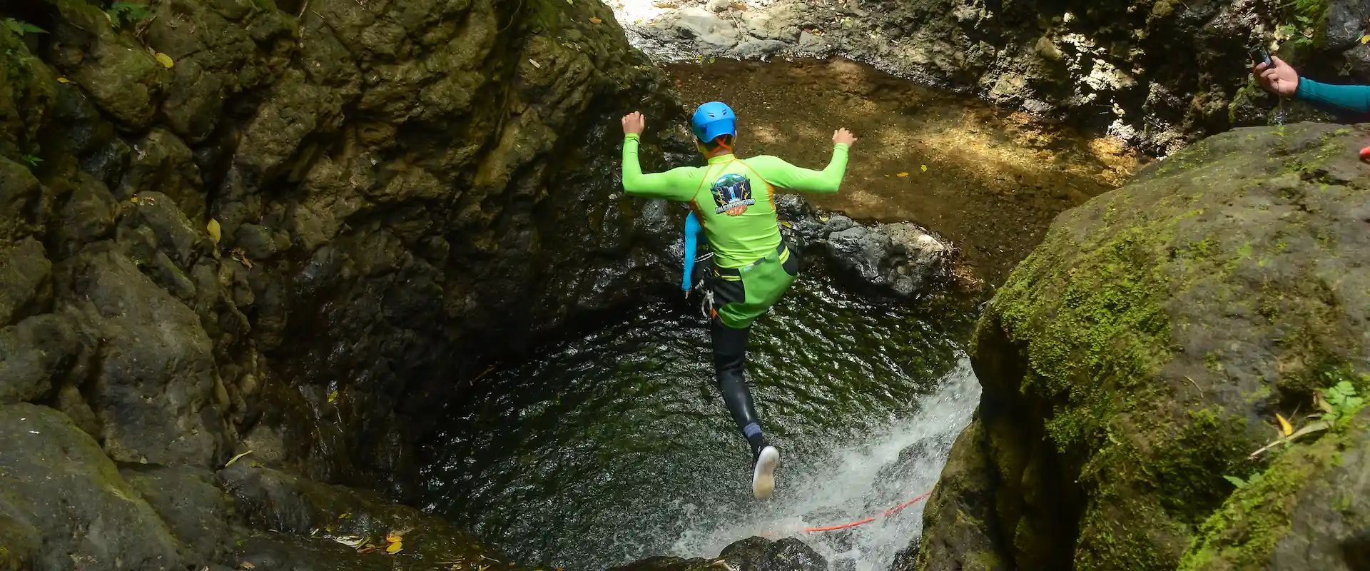 Cliff jump into a canyon pool