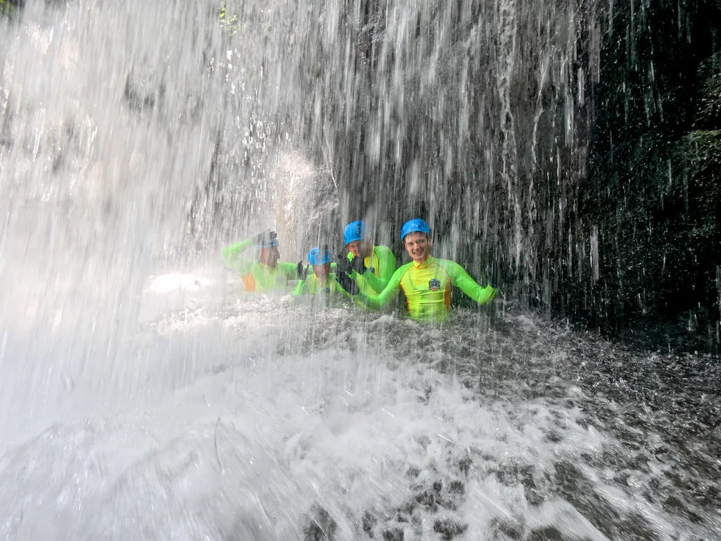 A beginner-friendly canyoning group enjoying a controlled descent in North Bali