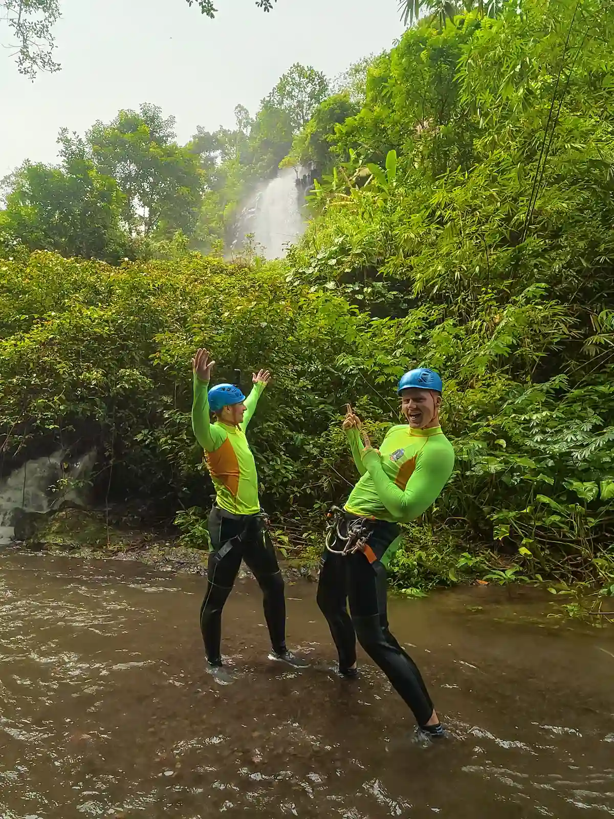 Two canyoners celebrating in the river during a canyon break