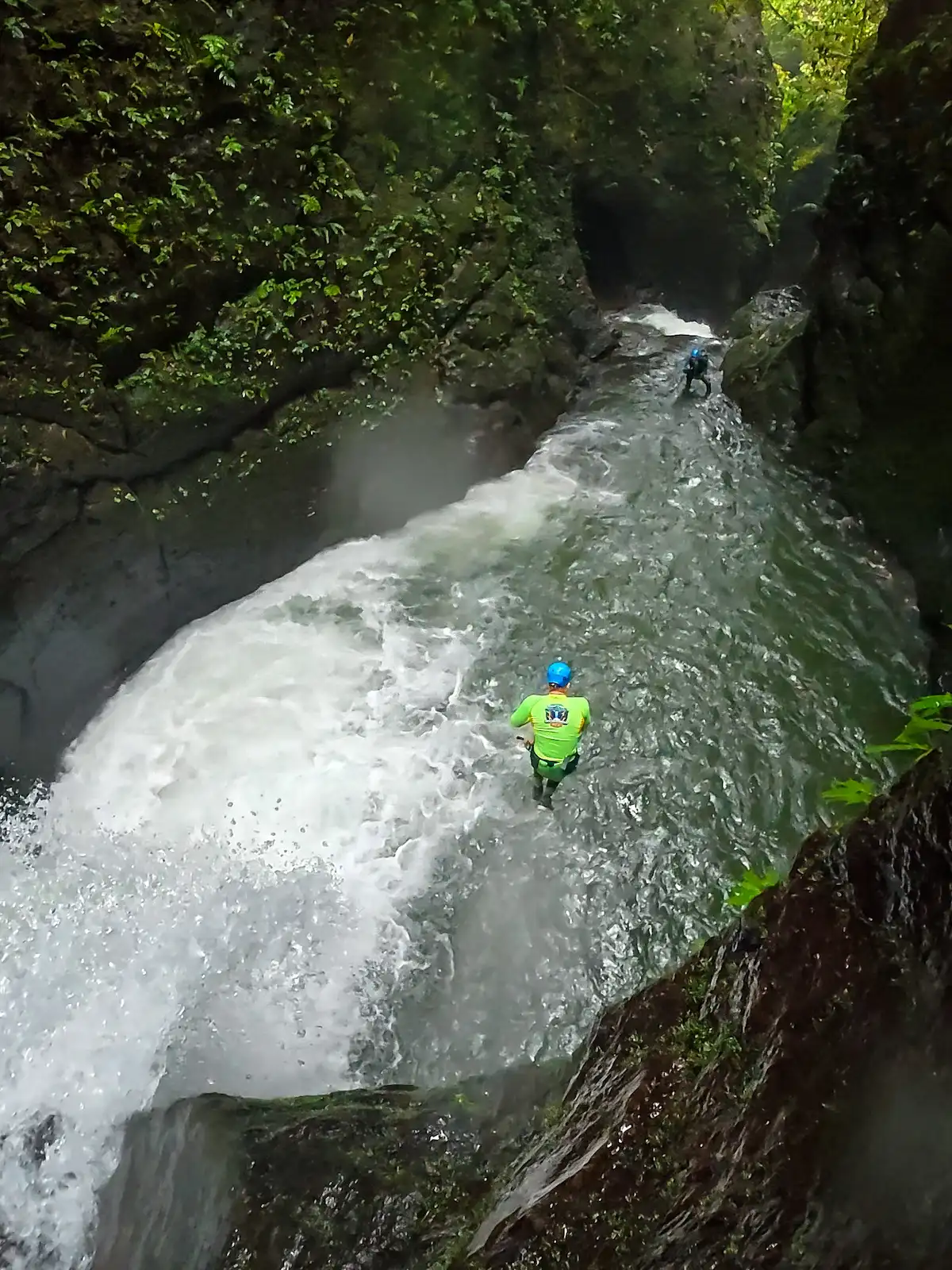 Canyoners moving through a powerful whitewater section on the Asri Challenge Flow route