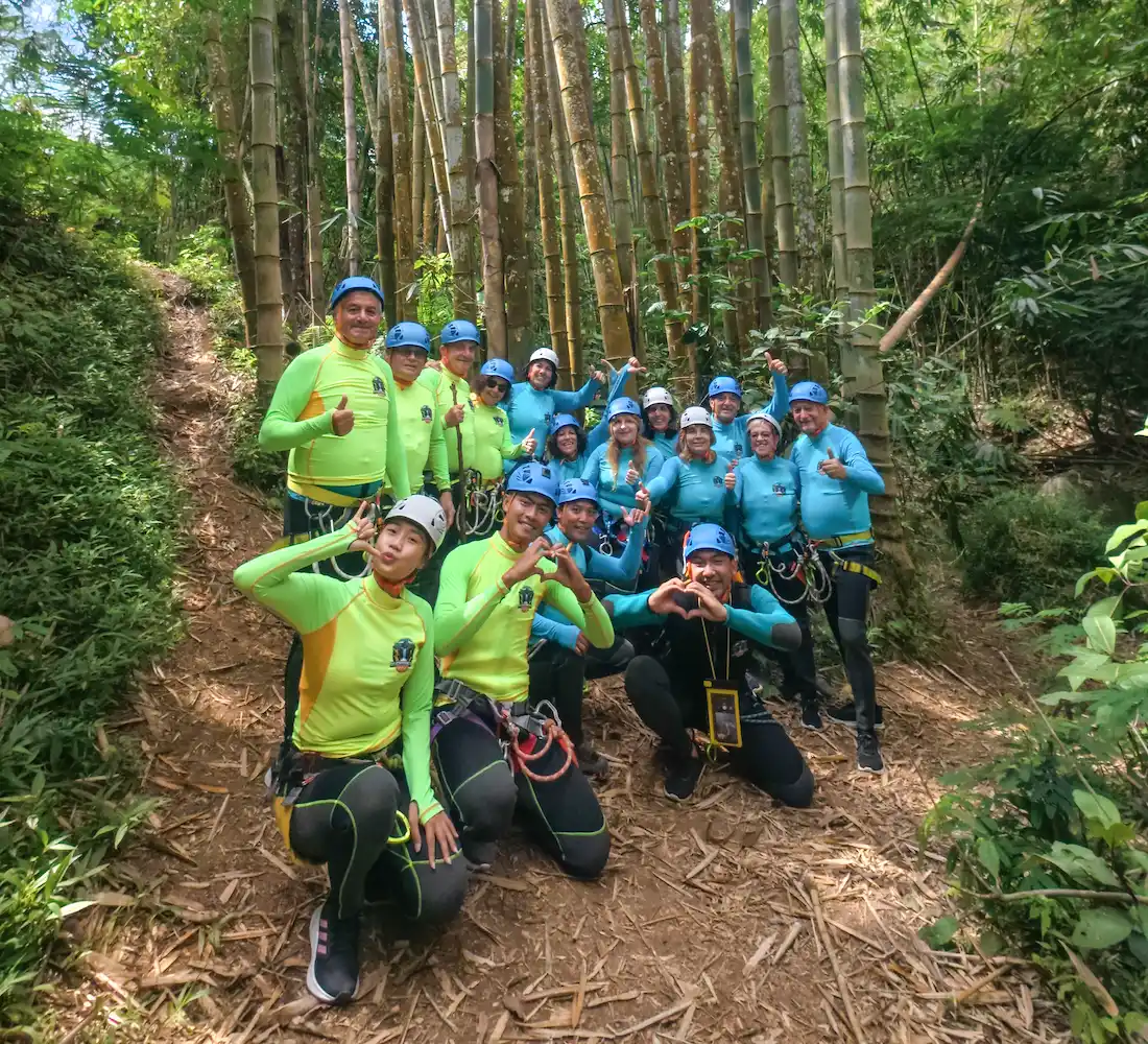Local canyoning guides with a group in helmets and harnesses in North Bali